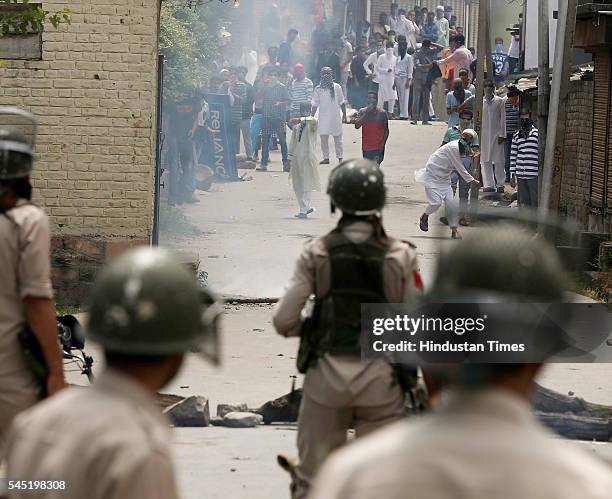 Kashmiri protesters pelting stones at the police and paramilitary soldiers during clashes after the culmination of Eid-ul-Fitr congregational...