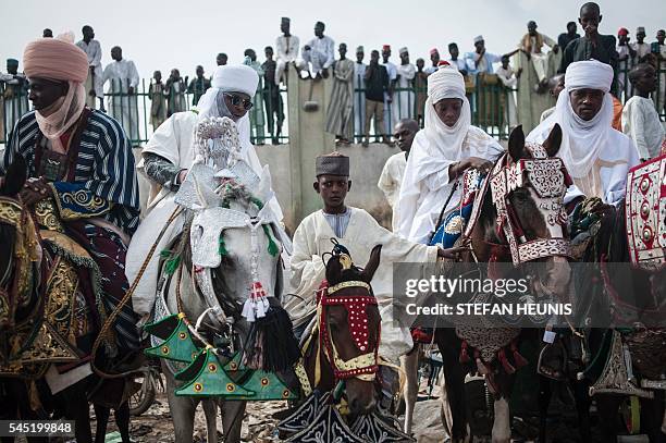 Boy sits on his horse waiting to see the Emir of Kano's procession passing during the Durbar procession in Kano, northern Nigeria on July 6, 2016....