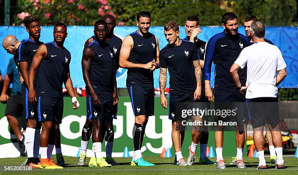 Andre-Pierre Gignac of France speaks with head coach Didier Deschamps during a France training session ahead of their UEFA Euro 2016 Semi final...