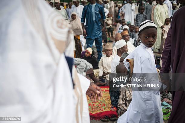 Boy carries his prayer mat to the Kofar Mata Eid Ground for morning prayer during the Durbar Festival in Kano, northern Nigeria on July 6, 2016. Kano...