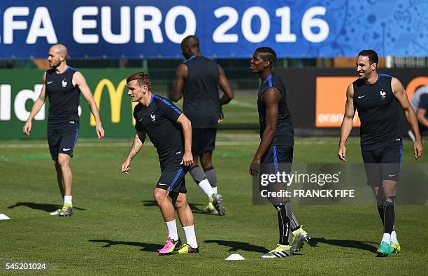 France's defender Christophe Jallet France's forward Antoine Griezmann and France's midfielder Paul Pogba and France's defender Adil Rami attend a...