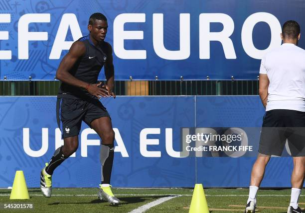 France's midfielder Paul Pogba attends a training session by France team football players in the southern French city of Marseille on July 6, 2016 on...