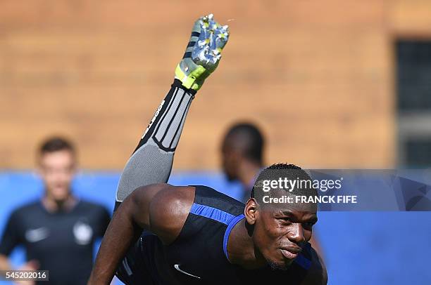 France's midfielder Paul Pogba attends a training session by France team football players in the southern French city of Marseille on July 6, 2016 on...