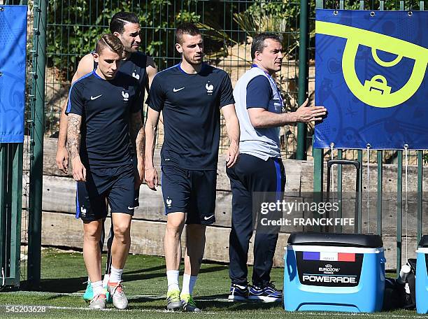 France's defender Lucas Digne, France's defender Adil Rami and France's midfielder Morgan Schneiderlin arrive for a training session in the southern...