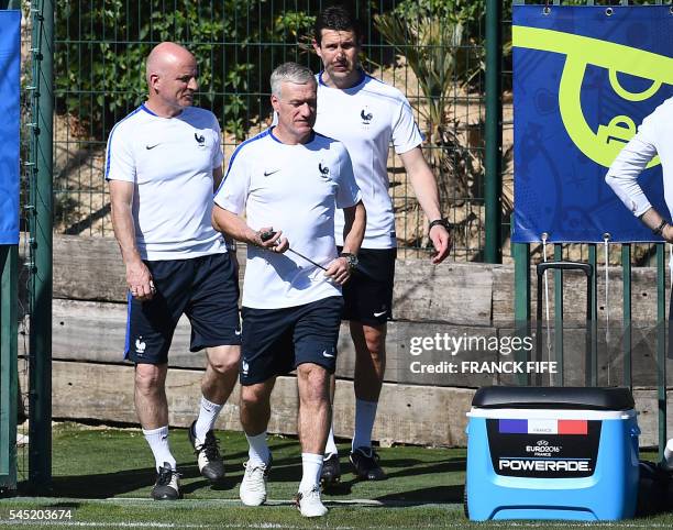 France's coach Didier Deschamps , assistant coach Guy Stephan , goalkeepers' coach Franck Raviot arrive for a training session in the southern French...