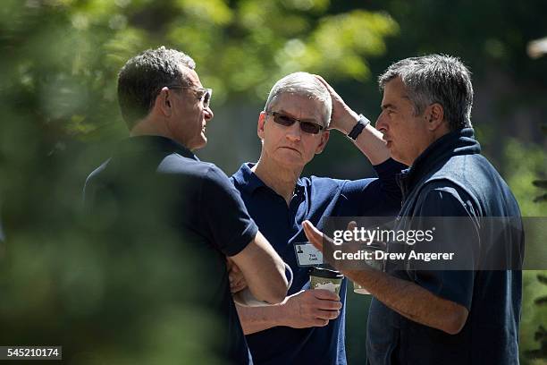 Bob Iger, chief executive officer of The Walt Disney Company, Tim Cook, chief executive officer of Apple Inc., and Eddy Cue, Apple senior vice...