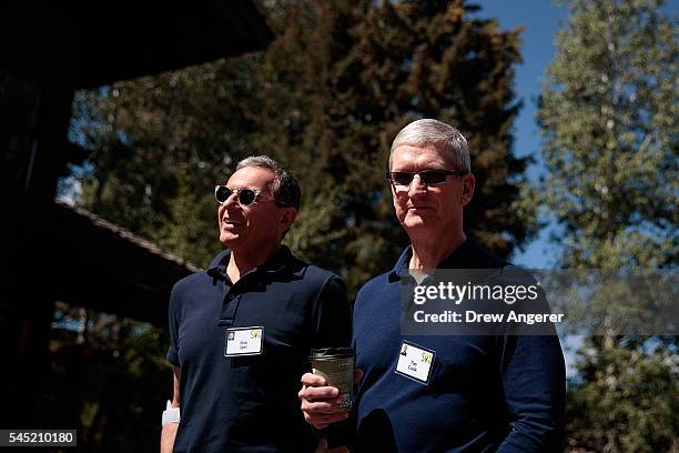 Bob Iger, chief executive officer of The Walt Disney Company, walks with Tim Cook, chief executive officer of Apple Inc., as they attend the annual...