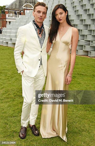 Jamie Campbell Bower and Matilda Lowther attend The Serpentine Summer Party co-hosted by Tommy Hilfiger on July 6, 2016 in London, England.