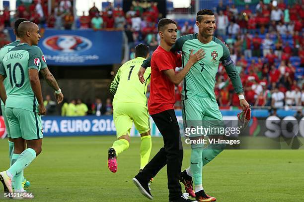 Cristiano Ronaldo of Portugal with a fan during the UEFA EURO semi-final match between Portugal and Wales on July 6, 2016 at the Stade de Lyon in...