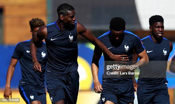 Paul Pogba of France jokes with Anthony Martial of France during a France training session ahead of their UEFA Euro 2016 Semi final against Germany...