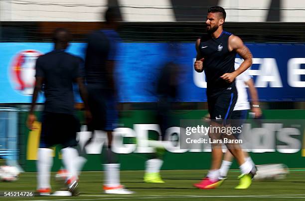 Olivier Giroud of France warms up during a France training session ahead of their UEFA Euro 2016 Semi final against Germany on July 6, 2016 in...