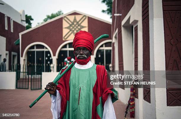 Member of the Emir's royal guard stands in the palace grounds before the start of the Durbar Festival in Kano, northern Nigeria on July 6, 2016. Kano...