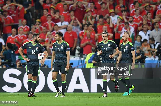 Joe Ledley, Hal Robson-Kanu], Gareth Bale and James Collins of Wales show their dejection after conceding a goal during the UEFA EURO 2016 semi final...