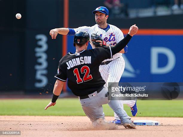 Second baseman Neil Walker of the New York Mets gets the force out on Chris Johnson of the Miami Marlins and throws to first to get Ichiro Suzuki for...