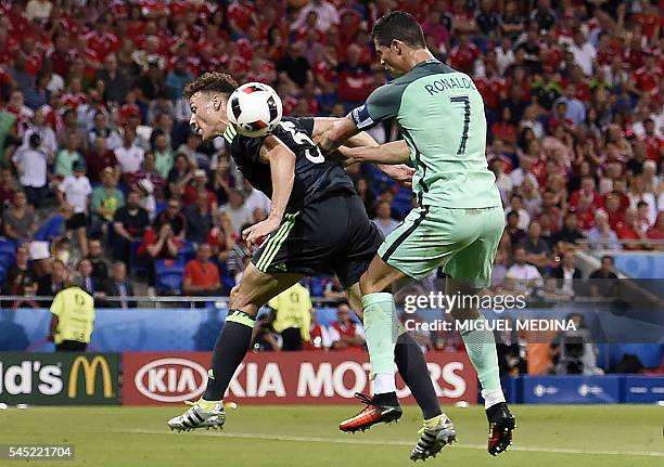 Wales' defender James Chester vies for the ball against Portugal's forward Cristiano Ronaldo during the Euro 2016 semi-final football match between...