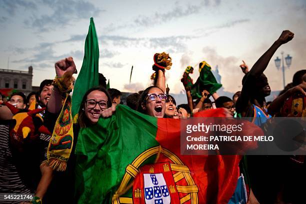 Portugal football team's supporters react to the first goal of Portugal's forward Cristiano Ronaldo as they watch the Euro 2016 semi-final football...