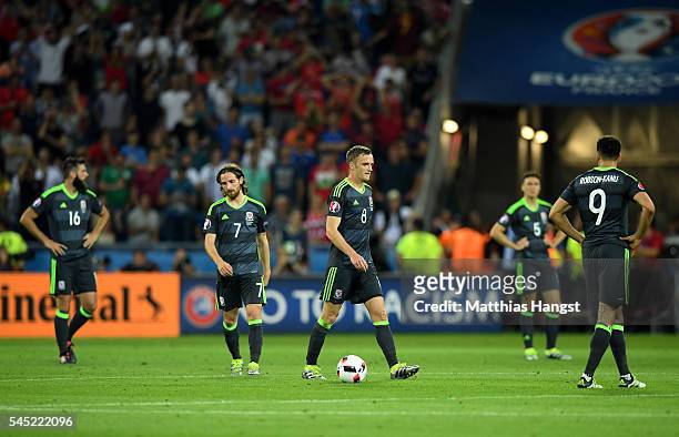 Wales players show their dejection after Portugal's second goal during the UEFA EURO 2016 semi final match between Portugal and Wales at Stade des...