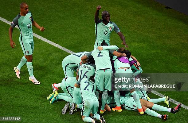 Portugal's players celebrate the opening goal scored by forward Cristiano Ronaldo during the Euro 2016 semi-final football match between Portugal and...