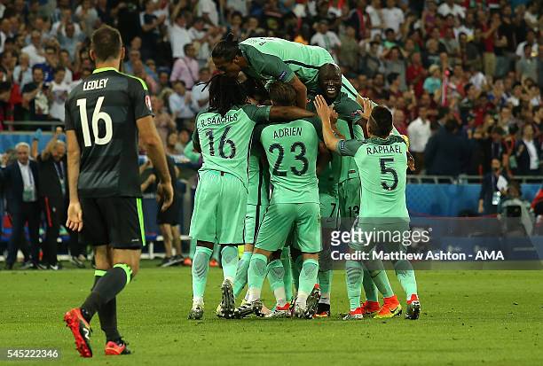 Nani of Portugal is mobbed by his team-mates after scoring a goal to make the score 2-0 during the UEFA Euro 2016 Semi Final match between Portugal...