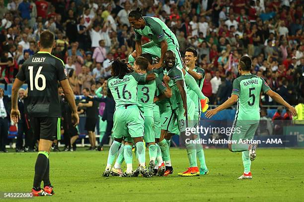 Nani of Portugal is mobbed by his team-mates after scoring a goal to make the score 2-0 during the UEFA Euro 2016 Semi Final match between Portugal...