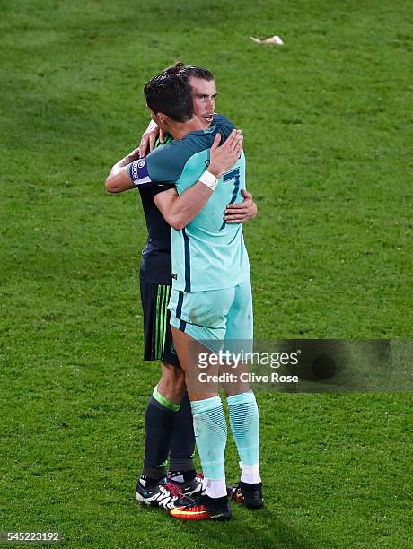 Gareth Bale of Wales and Cristiano Ronaldo of Portugal embrace after the UEFA EURO 2016 semi final match between Portugal and Wales at Stade des...