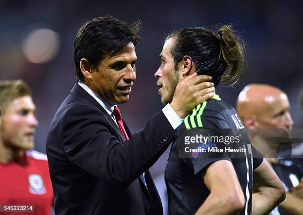 Chris Coleman manager of Wales consoles Gareth Bale of Wales after defeat in the UEFA EURO 2016 semi final match between Portugal and Wales at Stade...