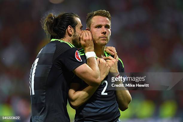 Gareth Bale consoles team-mate Chris Gunter of Wales after defeat in the UEFA EURO 2016 semi final match between Portugal and Wales at Stade des...