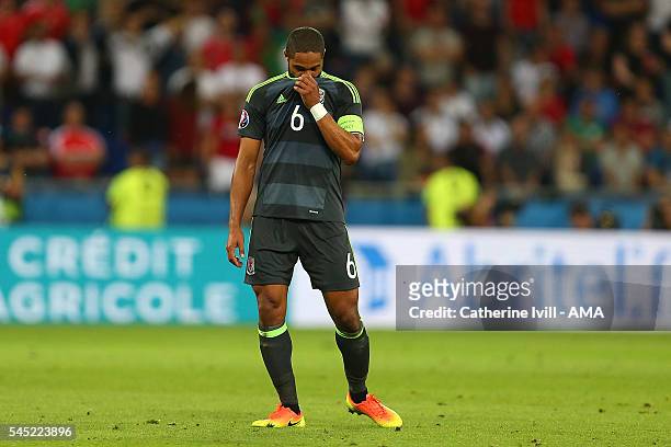 Ashley Williams of Wales looks dejected at the end of the UEFA Euro 2016 Semi Final match between Portugal and Wales at Stade des Lumieres on July 6,...