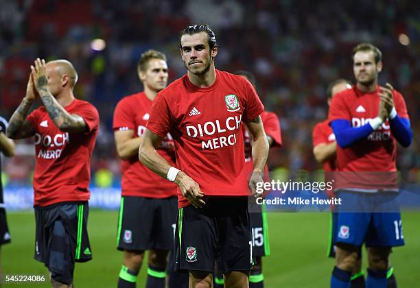 Gareth Bale of Wales wears a t-shirt displaying the word 'thanks' in welsh and french after defeat in the UEFA EURO 2016 semi final match between...