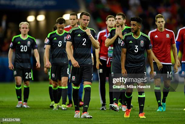 Dejected Chris Gunter, Neil Taylor and Wales players leave the pitch after the UEFA EURO 2016 semi final match between Portugal and Wales at Stade...