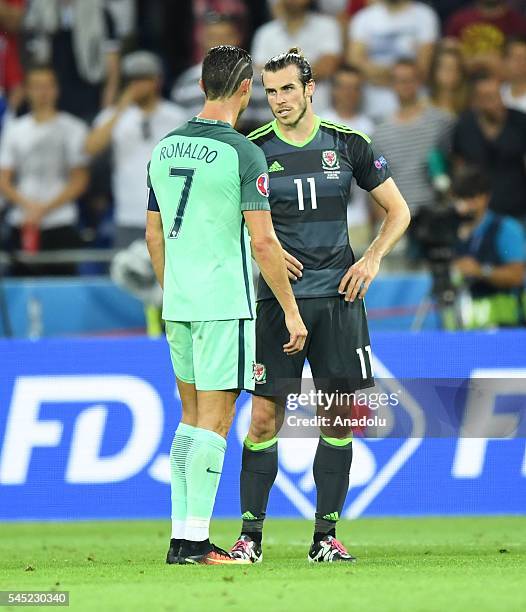 Gareth Bale of Wales speaks with Cristiano Ronaldo of Portugal after the UEFA Euro 2016 semi final match between Portugal and Wales at Stade de Lyon...