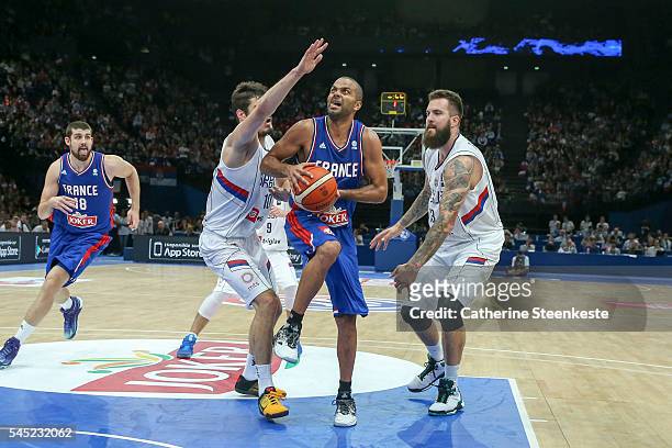 Tony Parker of France is at the basket against Nikola Kalinic and Miroslav Raduljica of Serbia during the International Friendly game between France...