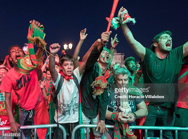 Portuguese supporters jubilate at their national team victory while watching it playing against Wales for semi-finals of UEFA Euro 2016 on a giant...