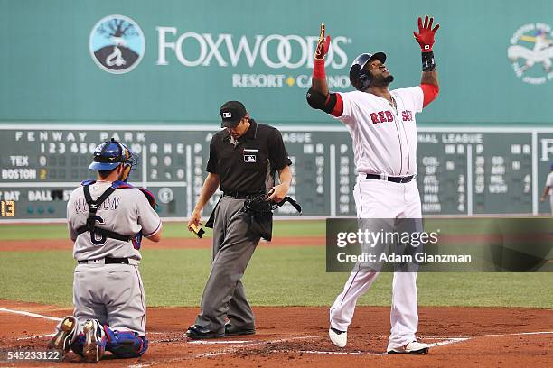 David Ortiz of the Boston Red Sox celebrates after hitting a two-run home run in the first inning during the game against the Texas Rangers at Fenway...