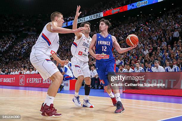 Nando De Colo of France is trying to pass the ball against Nikola Jokic and Milos Teodosic of Serbia during the International Friendly game between...