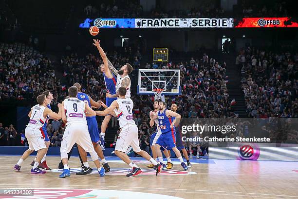 Joffrey Lauvergne of France and Miroslav Raduljica of Serbia are trying to get the ball at the tip off of the International Friendly game between...