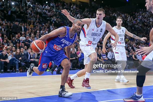 Tony Parker of France is driving at the basket against Nikola Jokic of Serbia during the International Friendly game between France v Serbia at...