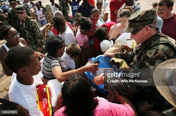 Mississippi residents scramble for donated goods handed out by members of the Alabama National Guard at a distribution center September 4, 2005 in...