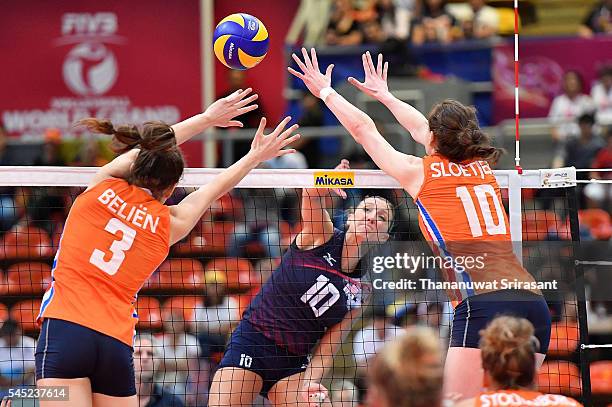 Jordan Larson-Burbach of USA hit the ball pass block of Yvon Belien and Lonneke Sloetjes of Netherlands during day one of the FIVB World Grand Prix...