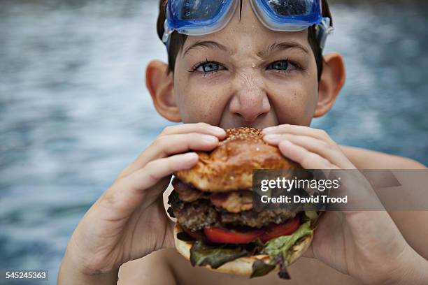 boy eating burger - david swallow stock pictures, royalty-free photos & images