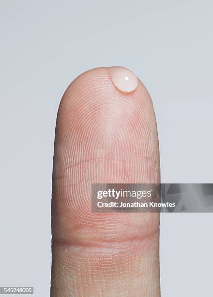 finger with a bead of water - indice dito umano foto e immagini stock