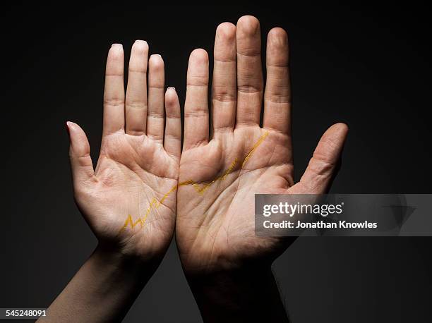 two hands side by side connected by graph - handfläche stock-fotos und bilder