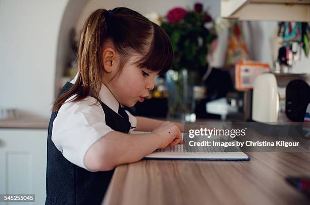 young schoolgirl reading before school - reading england stock-fotos und bilder