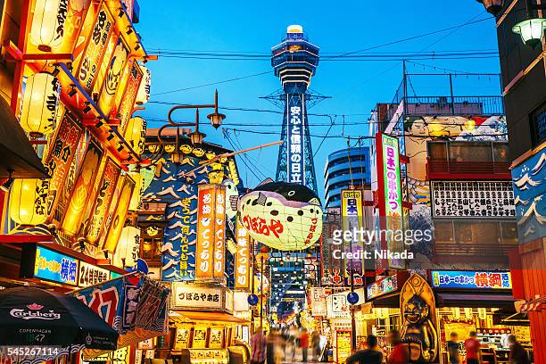 osaka tower and view of the neon advertisements shinsekai district - osaka prefecture stock pictures, royalty-free photos & images