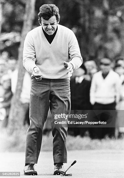 English golf player Tony Jacklin dropping his putter in anguish after missing a putt on the 13th green during the 2nd round of the British Open Golf...