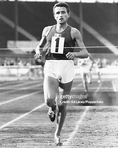 French middle and long distance runner, Michel Jazy crossing the finish line of his race, at White City Stadium, London, October 12th 1964.
