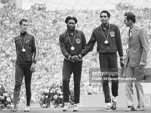 From left, silver medallist Guy Drut of France, gold medallist Rod Milburn of the United States and bronze medallist Tom Hill of the United States,...