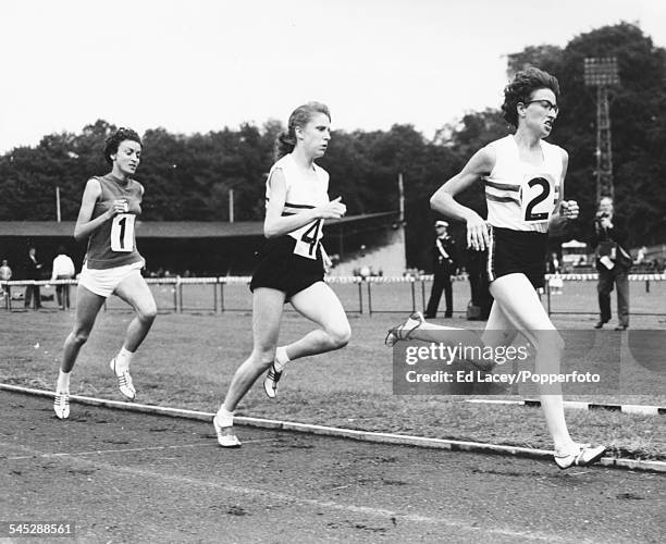 British middle distance runners Joy Jordan and Joyce Smith lead the field to finish first and second in the 800m race at a track and field meeting...