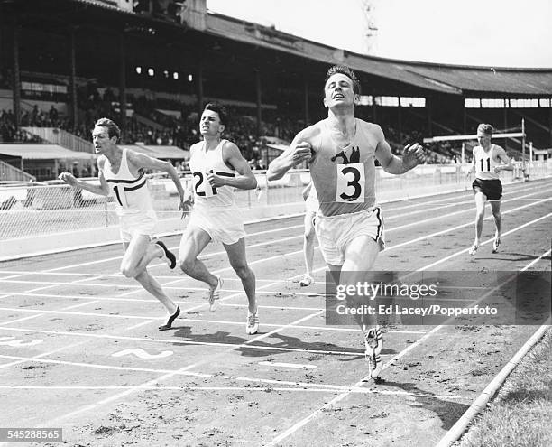 British runners Brian Hewson , John Wenk and Tom Farrell crossing the finish line of the 800m race, at the Amateur Athletics Association...