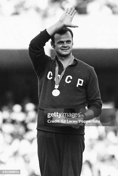 Latvian and soviet athlete Janis Lusis waves from the podium after ...